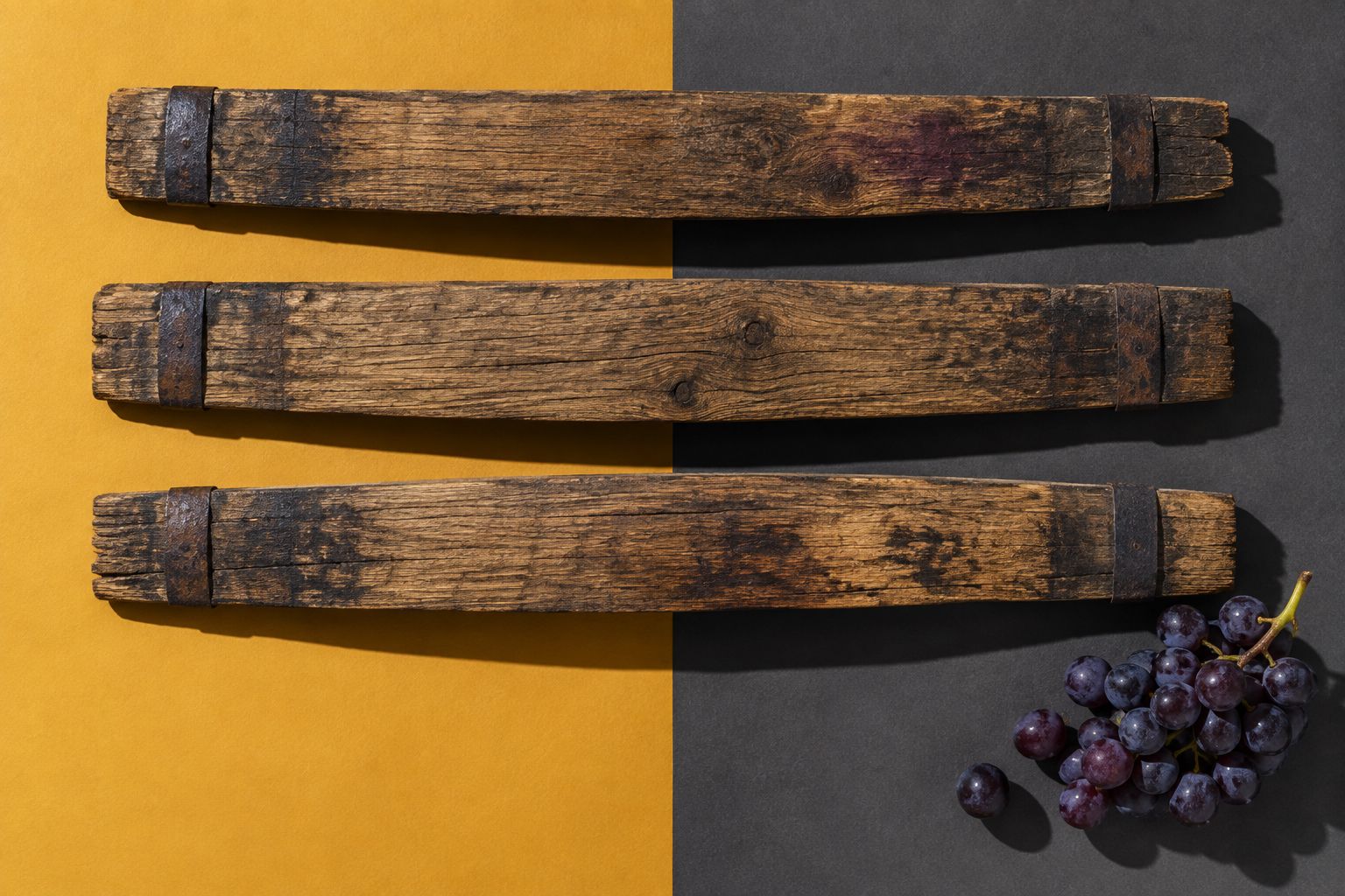 Oak barrel staves on a gold and charcoal background